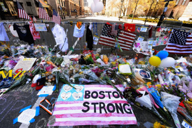 BOSTON, MA - APRIL 21: Items are placed by people visiting a makeshift memorial for victims near the site of the Boston Marathon bombings at the intersection of Boylston Street and Berkley Street two days after the second suspect was captured on April 21, 2013 in Boston, Massachusetts. A manhunt for Dzhokhar A. Tsarnaev, 19, a suspect in the Boston Marathon bombing ended after he was apprehended on a boat parked on a residential property in Watertown, Massachusetts. His brother Tamerlan Tsarnaev, 26, the other suspect, was shot and killed after a car chase and shootout with police. The bombing, on April 15 at the finish line of the marathon, killed three people and wounded at least 170. (Photo by Kevork Djansezian/Getty Images)